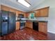 Well-equipped kitchen with modern black appliances, wood cabinets, and wood floors at 110 Silverthorne Dr, Douglasville, GA 30134