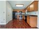 Efficient kitchen features stainless steel appliances, wood cabinets, and hardwood floors at 110 Silverthorne Dr, Douglasville, GA 30134