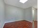 An empty room with dark wood floors, white walls and a drop ceiling with recessed lighting at 110 Silverthorne Dr, Douglasville, GA 30134