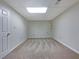A room with light tan carpet, white walls and drop ceilings with recessed lighting at 110 Silverthorne Dr, Douglasville, GA 30134