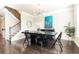 Bright dining room with modern chandelier and a black table and chairs, and staircase in the background at 3133 Quinn Pl, Atlanta, GA 30341