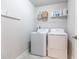 Compact laundry room with washer, dryer, and shelving at 3133 Quinn Pl, Atlanta, GA 30341