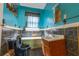 Outdated bathroom with blue walls, blue tile and fixtures, and a single-sink vanity at 969 Byron Sw Dr, Atlanta, GA 30310