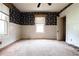 Bedroom with wallpaper, windows for natural light, and white wainscoting at 969 Byron Sw Dr, Atlanta, GA 30310