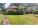 Exterior shot of a single-story home, with a red roof and overgrown landscaping at 969 Byron Sw Dr, Atlanta, GA 30310