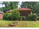 Charming single-story home with a red roof, screened front porch, and mature landscaping at 969 Byron Sw Dr, Atlanta, GA 30310