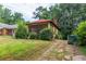 Exterior of a single-story home with a red roof and a screened front porch at 969 Byron Sw Dr, Atlanta, GA 30310