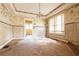 Living room with a view into another room, large windows, and a chandelier at 969 Byron Sw Dr, Atlanta, GA 30310