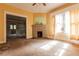 Living room features a brick fireplace, windows with natural light, and a doorway at 969 Byron Sw Dr, Atlanta, GA 30310