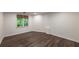 Basement with window and modern wood-look floors, offering a cozy and functional space at 10650 Centennial Dr, Alpharetta, GA 30022
