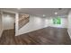 Finished basement area with wood-look floors, stairs, and a window offering natural light at 10650 Centennial Dr, Alpharetta, GA 30022