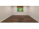 Basement with wood-look floors and a window, perfect for a functional and inviting space at 10650 Centennial Dr, Alpharetta, GA 30022
