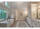 Bright bathroom featuring a glass shower, soaking tub and stained glass window at 10650 Centennial Dr, Alpharetta, GA 30022