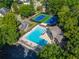 Aerial view of a community pool area with lounge chairs, tennis courts, and a clubhouse at 10650 Centennial Dr, Alpharetta, GA 30022