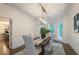 Bright dining room featuring a modern light fixture and a large window overlooking the outdoor scenery at 10650 Centennial Dr, Alpharetta, GA 30022