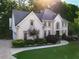 A beautiful home with a well-manicured lawn, mature trees, and a charming facade with great curb appeal at 10650 Centennial Dr, Alpharetta, GA 30022
