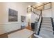 Elegant foyer with soaring ceilings, a staircase with decorative railings, and hardwood floors with a decorative area rug at 10650 Centennial Dr, Alpharetta, GA 30022
