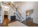 Elegant foyer with soaring ceilings, a staircase with decorative railings, and hardwood floors with a decorative area rug at 10650 Centennial Dr, Alpharetta, GA 30022