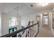 Upstairs hallway with black and white trim and half-moon window on the stair landing at 10650 Centennial Dr, Alpharetta, GA 30022