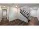 Hallway with wood floors and stairs leading up to the next level of the home at 10650 Centennial Dr, Alpharetta, GA 30022
