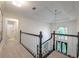 Upstairs hallway with black and white trim and half-moon window on the stair landing at 10650 Centennial Dr, Alpharetta, GA 30022