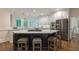 Gourmet kitchen features white cabinetry, stainless steel appliances, a central island, and a breakfast bar area at 10650 Centennial Dr, Alpharetta, GA 30022