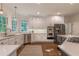Gourmet kitchen features white cabinetry, stainless steel appliances, a central island, and ample counter space at 10650 Centennial Dr, Alpharetta, GA 30022
