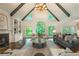 Inviting living room with fireplace, built-in shelving, and large windows showcasing lush greenery outside at 10650 Centennial Dr, Alpharetta, GA 30022