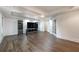 Finished basement with modern wood floors, a tray ceiling, and built in entertainment center at 10650 Centennial Dr, Alpharetta, GA 30022
