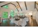Spacious living room with vaulted ceilings, exposed beams, abundant natural light, and hardwood floors at 10650 Centennial Dr, Alpharetta, GA 30022