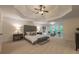 Spacious main bedroom with tray ceilings, plush carpet, seating area, and large windows at 10650 Centennial Dr, Alpharetta, GA 30022