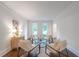 Cozy sitting room featuring comfortable seating, natural light, and a stylish rug on hardwood flooring at 10650 Centennial Dr, Alpharetta, GA 30022