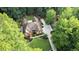 Aerial view of a brick home with mature trees, manicured lawn, and extended driveway at 2525 Fairview Dr, Cumming, GA 30041
