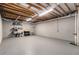 Unfinished basement shows exposed rafters and gray walls and floor at 2525 Fairview Dr, Cumming, GA 30041