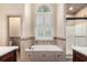 Garden tub with tile surround and separate shower in this spacious bathroom at 2525 Fairview Dr, Cumming, GA 30041