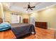 This main bedroom features a tray ceiling, ceiling fan, hardwood floors, and an ensuite bath at 2525 Fairview Dr, Cumming, GA 30041
