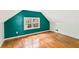 Finished attic with hardwood floors, painted walls, and a double window at 6719 Sunset Valley Cir, Rex, GA 30273