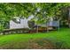 Well-maintained backyard with lush green lawn and wooden deck at 6719 Sunset Valley Cir, Rex, GA 30273