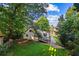 Scenic backyard view with wooden deck, lush green lawn and shady trees at 6719 Sunset Valley Cir, Rex, GA 30273