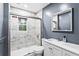 Bathroom with tiled walls, a glass shower door, single sink vanity and white cabinets at 6719 Sunset Valley Cir, Rex, GA 30273