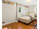 Cozy bedroom featuring hardwood floors, a light fixture, and a nature-themed border at 6719 Sunset Valley Cir, Rex, GA 30273