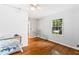 Bedroom featuring hardwood floors, window with natural light and white painted walls at 6719 Sunset Valley Cir, Rex, GA 30273