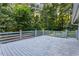 Expansive gray wooden deck surrounded by lush greenery, creating a private outdoor space for relaxation and leisure at 6719 Sunset Valley Cir, Rex, GA 30273