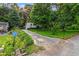 Property view showing an overgrown driveway leading up to the house at 6719 Sunset Valley Cir, Rex, GA 30273