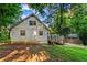 Exterior side view of home featuring a quaint design, surrounding greenery and wooden deck for relaxation at 6719 Sunset Valley Cir, Rex, GA 30273