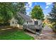 View of back exterior featuring a deck and a driveway with some greenery at 6719 Sunset Valley Cir, Rex, GA 30273
