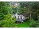 House surrounded by lush greenery, featuring a deck and an inviting atmosphere at 6719 Sunset Valley Cir, Rex, GA 30273