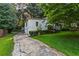 Driveway view of house exterior with a well-maintained lawn and mature trees at 6719 Sunset Valley Cir, Rex, GA 30273