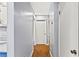 Hallway featuring hardwood floors, neutral painted walls, and white trim at 6719 Sunset Valley Cir, Rex, GA 30273