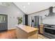 Open kitchen with butcher block island, stainless steel appliances, and bright lighting at 6719 Sunset Valley Cir, Rex, GA 30273